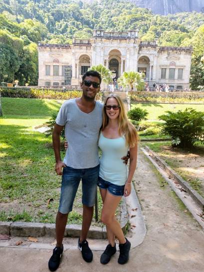 Two people standing in front of a building

Description automatically generated