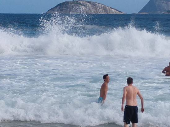 A group of people standing next to a body of water

Description automatically generated
