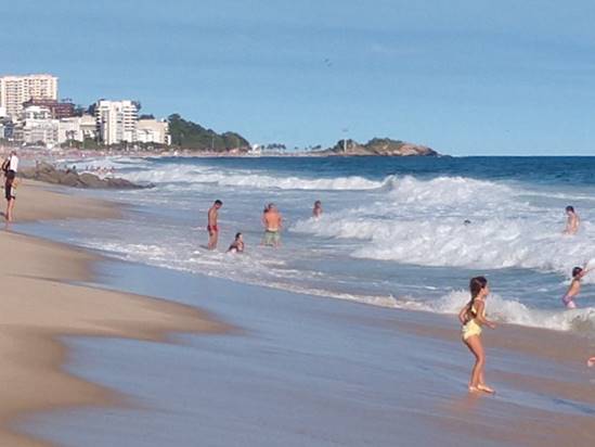 A group of people walking on a beach

Description automatically generated