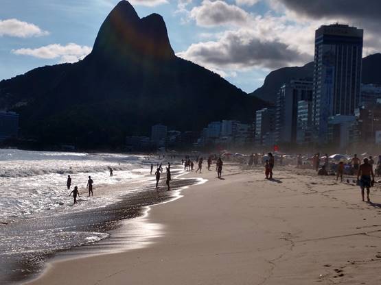 A group of people walking on a beach

Description automatically generated