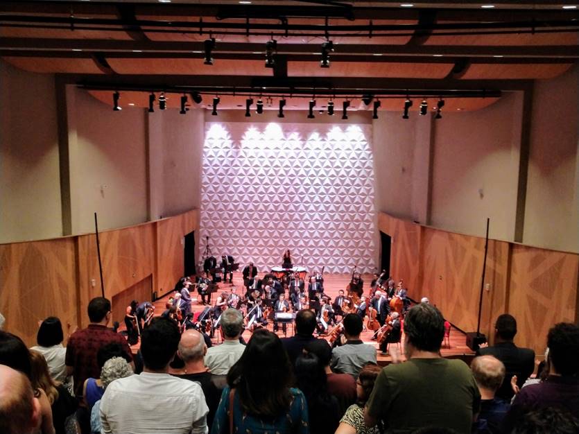 A group of people standing in front of a crowd

Description automatically generated