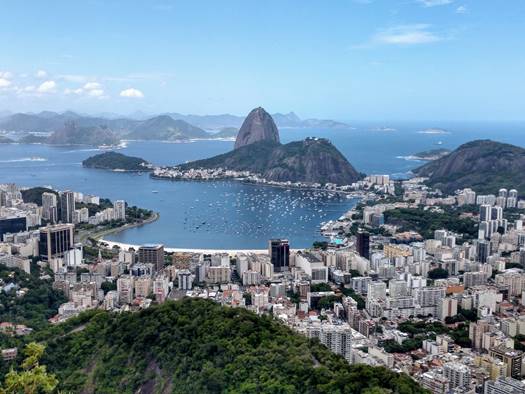 A large body of water with a mountain in the background

Description automatically generated