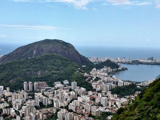 A large body of water with a mountain in the background

Description automatically generated