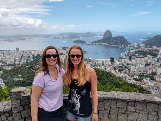 A person standing in front of a mountain

Description automatically generated